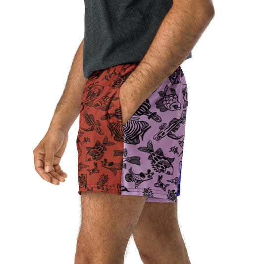 Side view of a person wearing the Harlequin recycled unisex shorts with hand in pocket