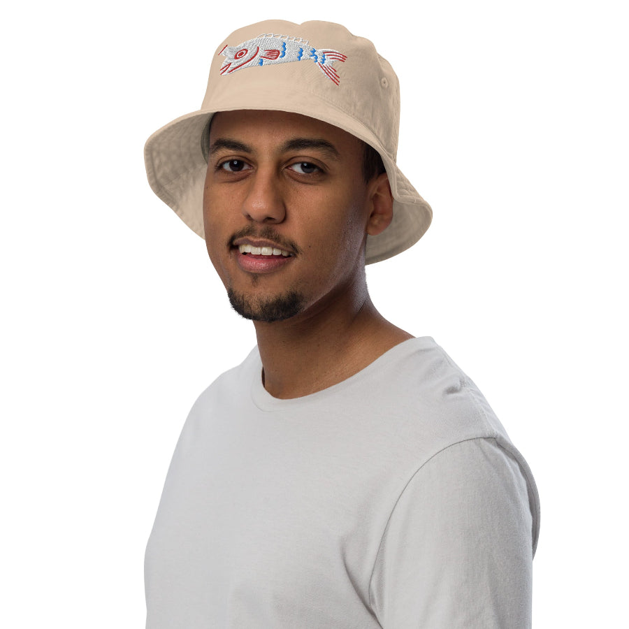 A man wearing a tan Fishful Thinking organic bucket hat with embroidered fish design