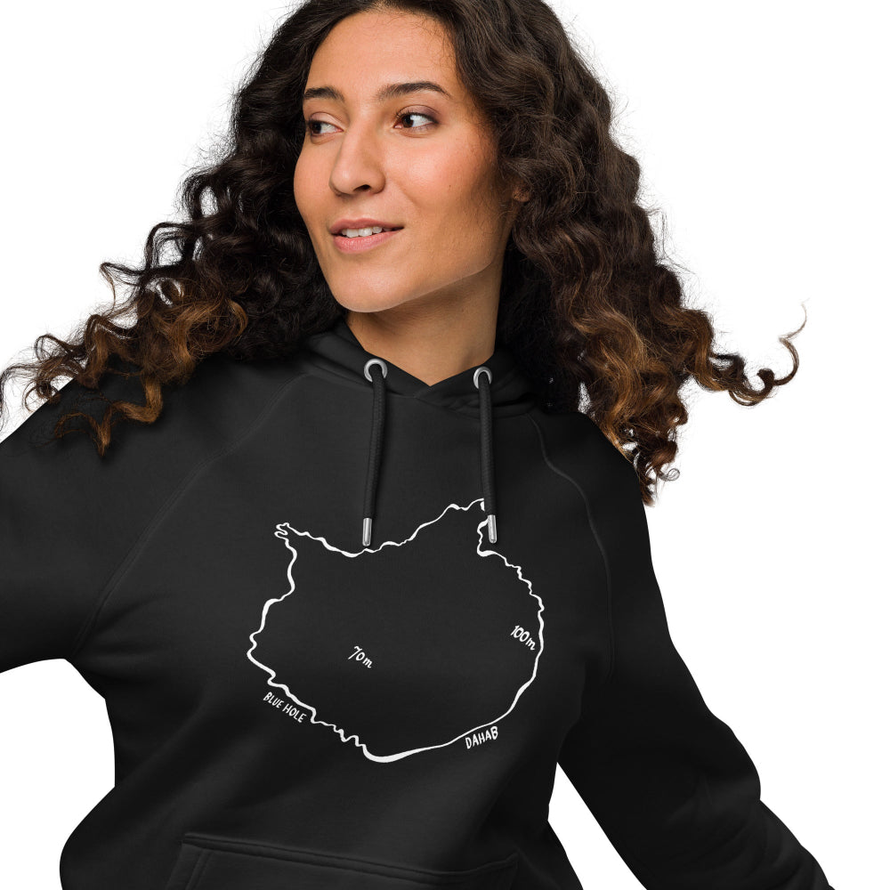 A woman wearing the Blue Hole Eco Hoodie in black, inspired by the Blue Hole freediving site in Dahab