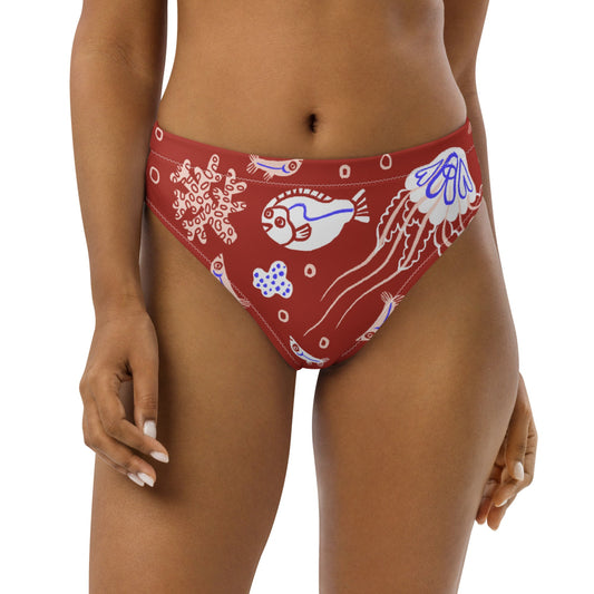 A high-waisted red bikini bottom with a pattern of blue fish and sea creatures.