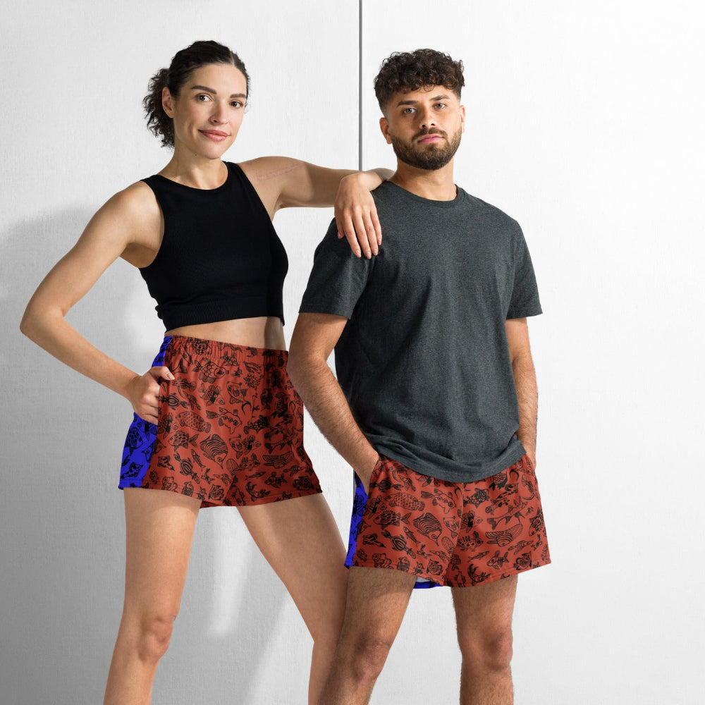 A couple wearing the Harlequin recycled unisex shorts in a casual leisure setting