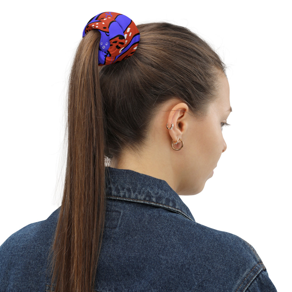 The Octopus Buff worn as a hairband in a woman’s ponytail
