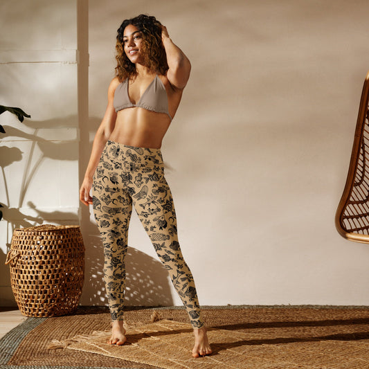 A cheerful woman wearing Plenty of Fish in The Sea recycled leggings in a studio setting, front view