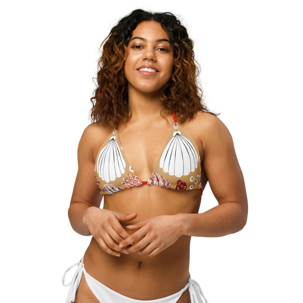 Front view of a woman wearing the Venus’ Secret recycled bikini top with straight binding