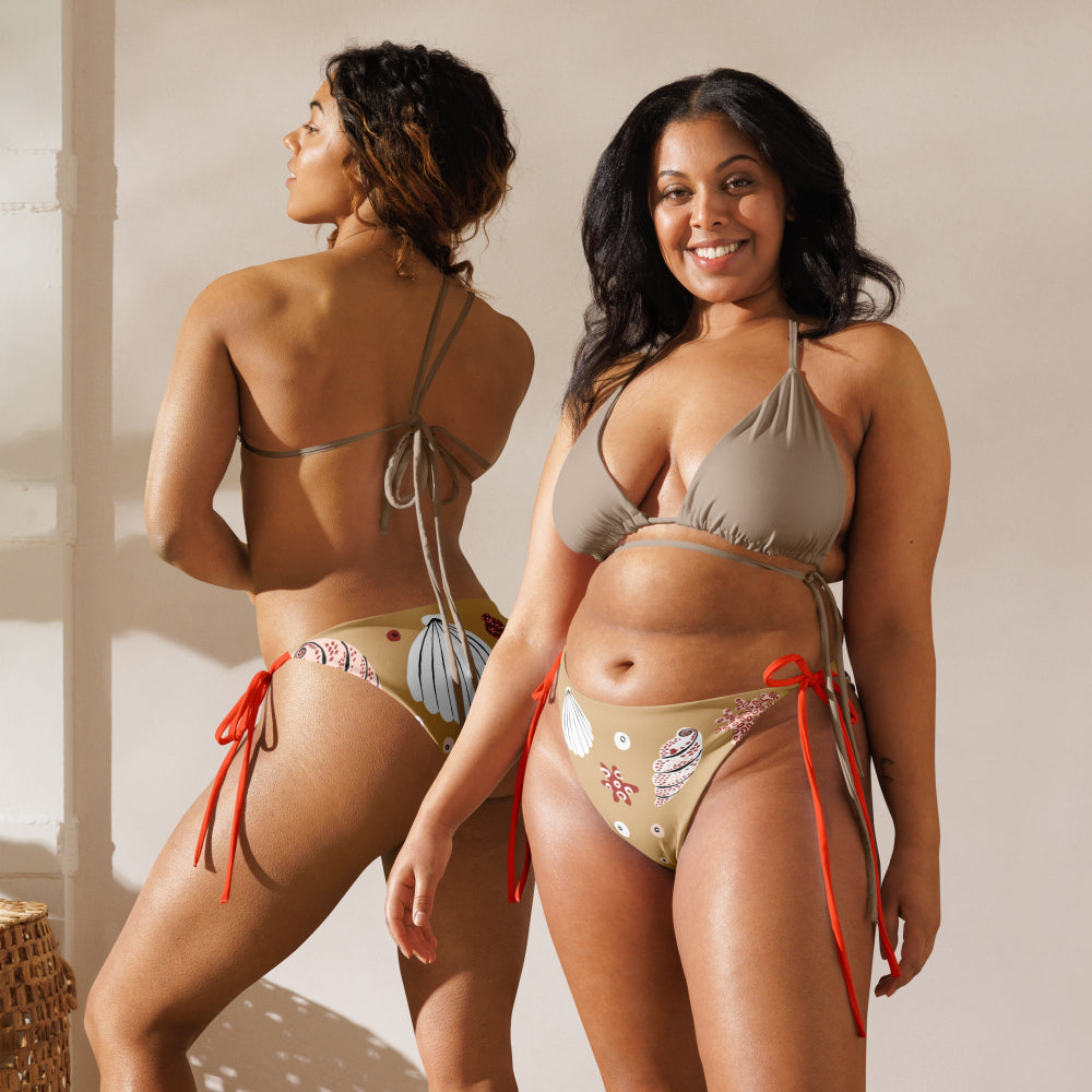 Two women wearing the Venus’ Secret recycled bikini bottom in a studio setting, one front view and one back view