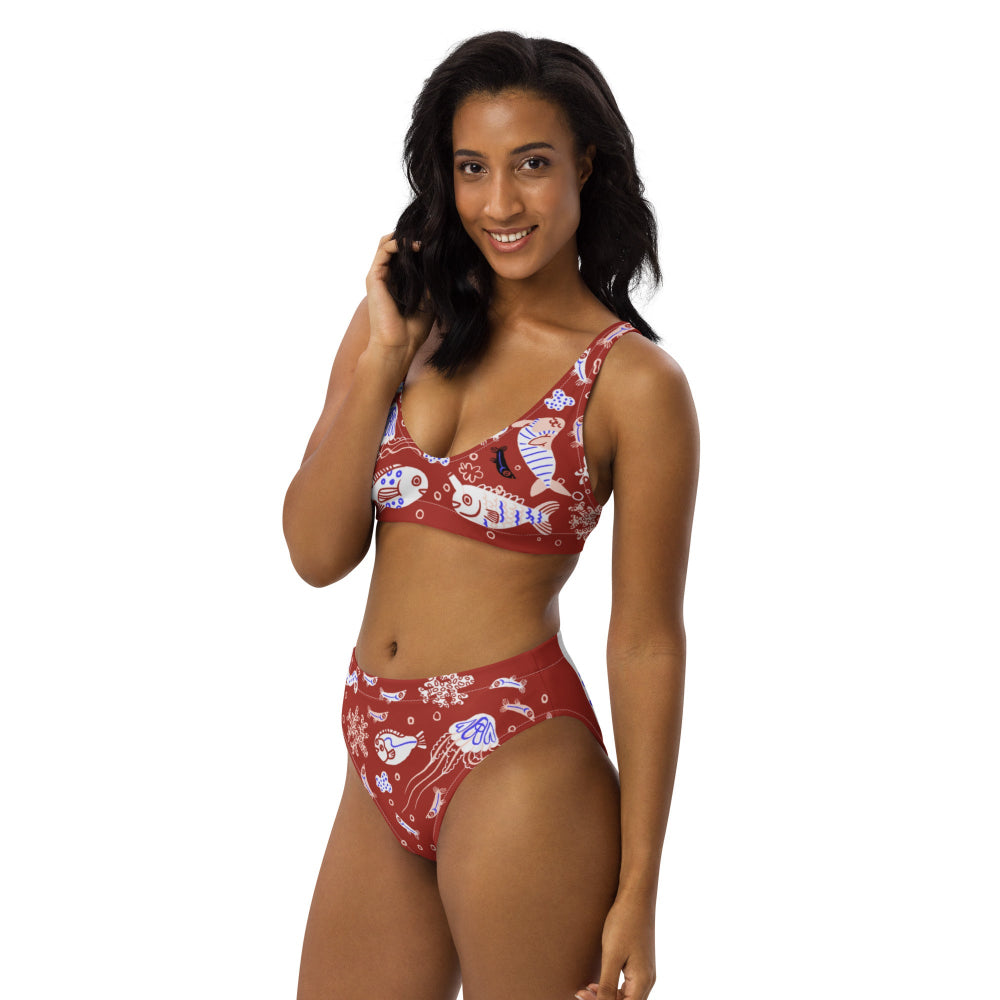 Right front view of a person wearing the Funny Fishes recycled bikini set in Red