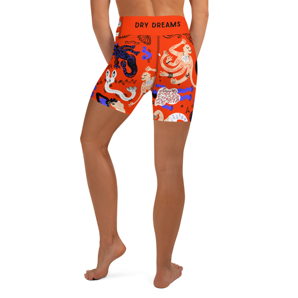 Back view of a person wearing Clownfish Red Mermaid Frenzy yoga shorts with a high waistband
