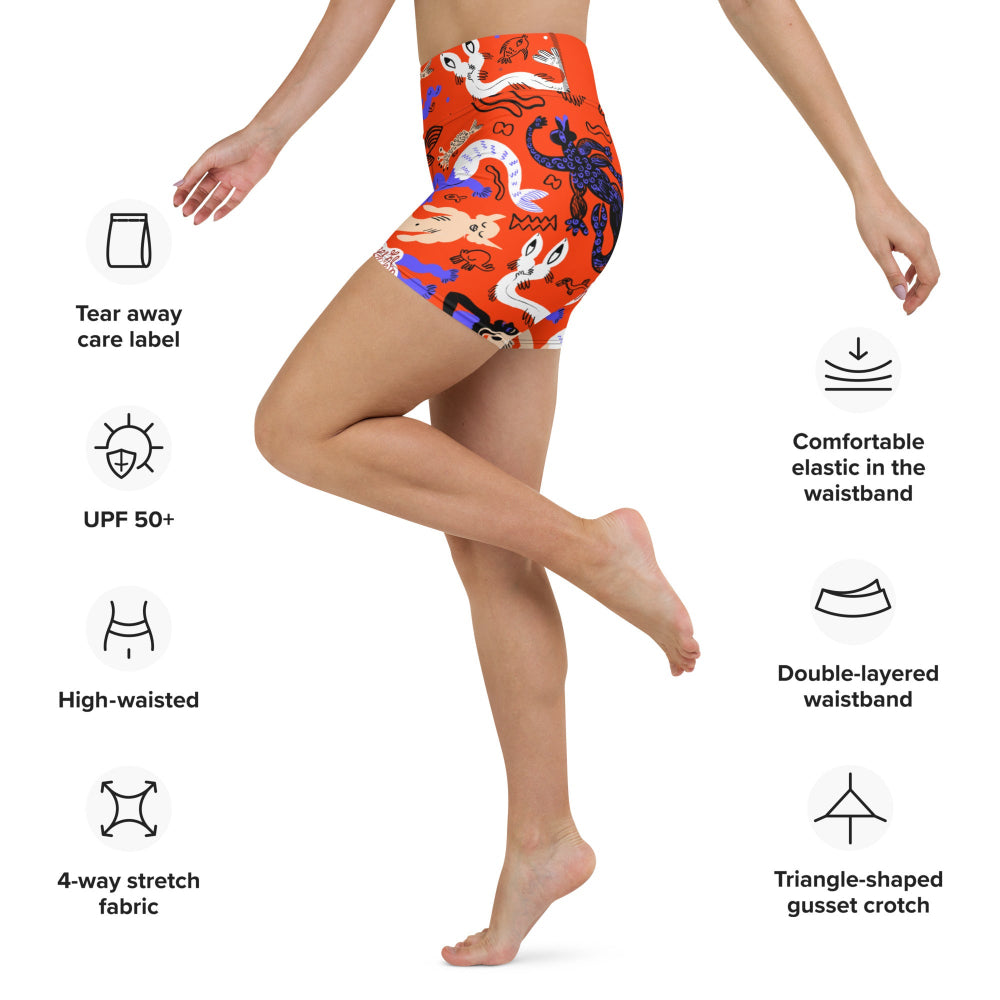 Right side view of a person wearing Clownfish Red Mermaid Frenzy yoga shorts with product feature information displayed