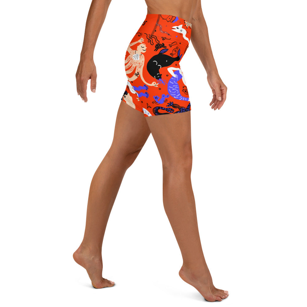 Right side view of a person wearing Clownfish Red Mermaid Frenzy yoga shorts