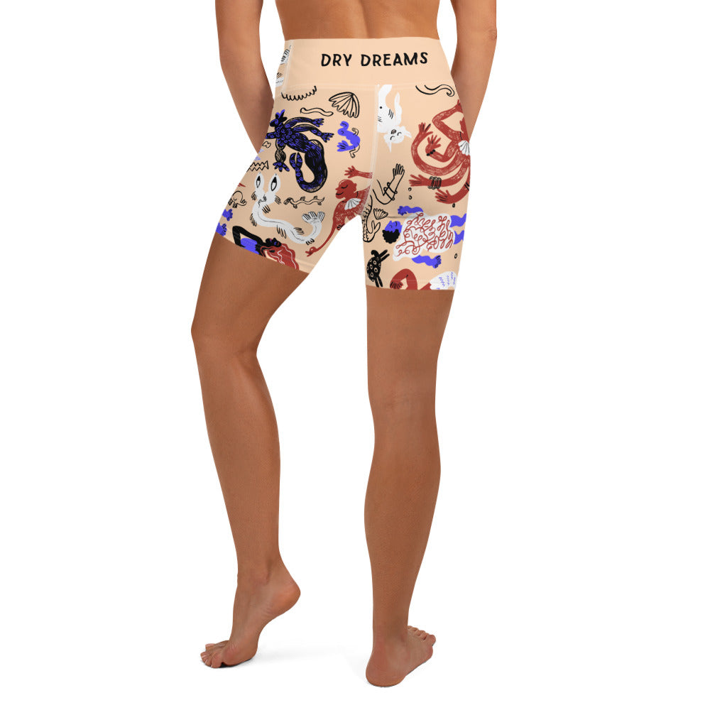Back view of a person wearing sand tan Mermaid Frenzy yoga shorts with a high waistband