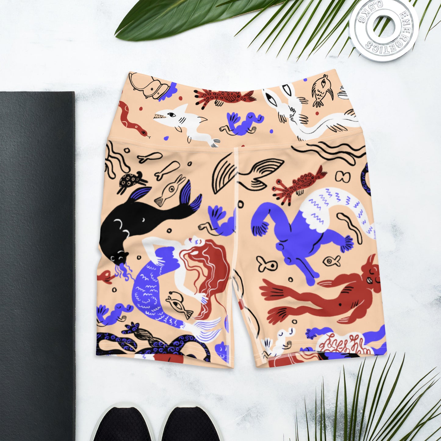 Sand tan Mermaid Frenzy yoga shorts laid flat with lifestyle elements